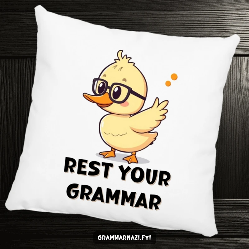 Funny duckling pillow with spectacles, pointing at an apostrophe, offering plush comfort and a touch of linguistic humor.