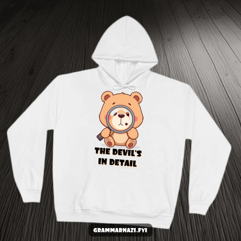 Warm and funny bear wearing a hoodie, inspecting a comma with a magnifying glass, symbolizing a love for grammar and language.