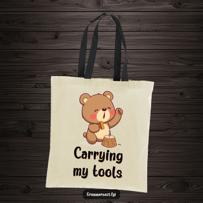 Funny tote bag showcasing a determined bear enthusiastically hammering a small nail into wood, ready for any task.